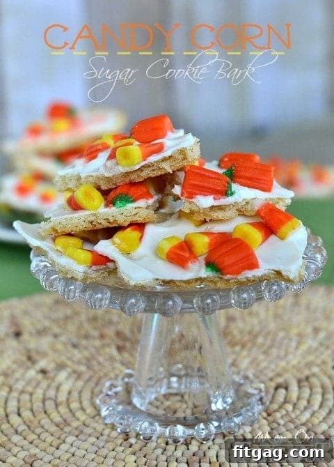 Vibrant Candy Corn Sugar Cookie Bark, perfect for Halloween festivities, displayed on a plate.