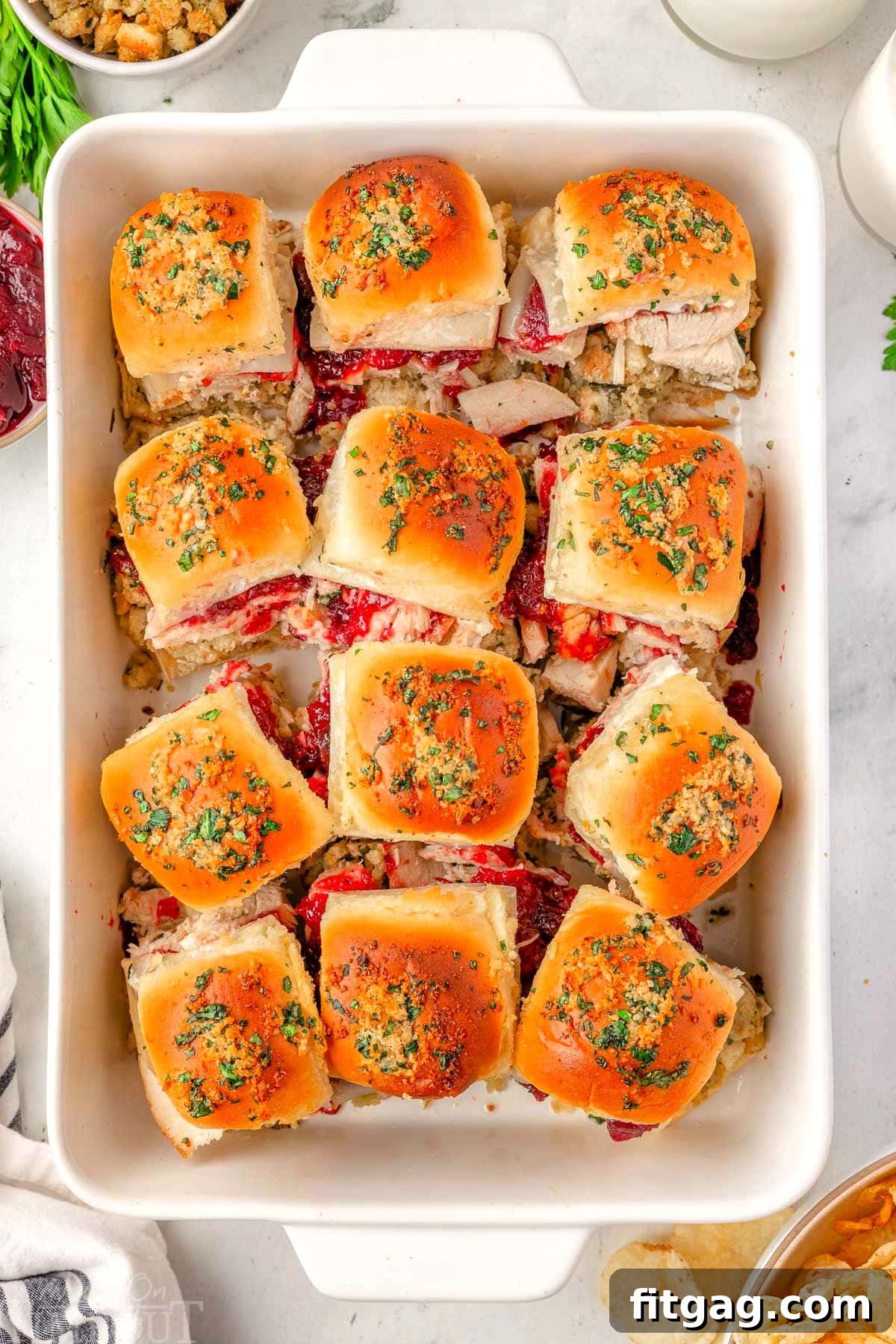 Petite Turkey Stacks 3 Overhead shot of 12 turkey sliders in a white baking dish ready to be enjoyed.