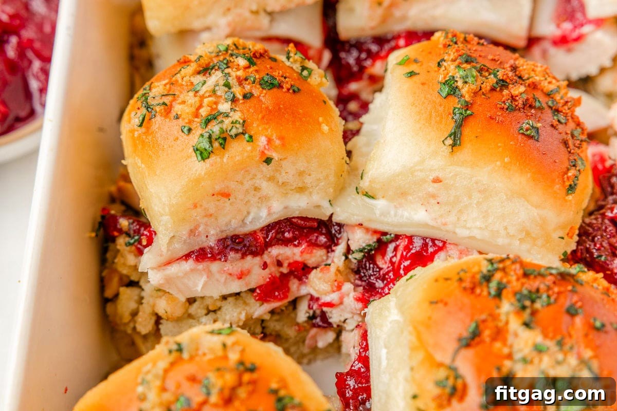 Petite Turkey Stacks 5 Wide shot of turkey cranberry sliders in white baking dish.