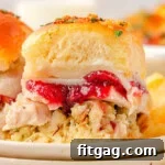 Petite Turkey Stacks 10 Two Turkey sliders sitting on small round plates stacked three high. Cranberry sauce, juicy turkey, and stuffing can all be seen in between the soft hawaiian roll.