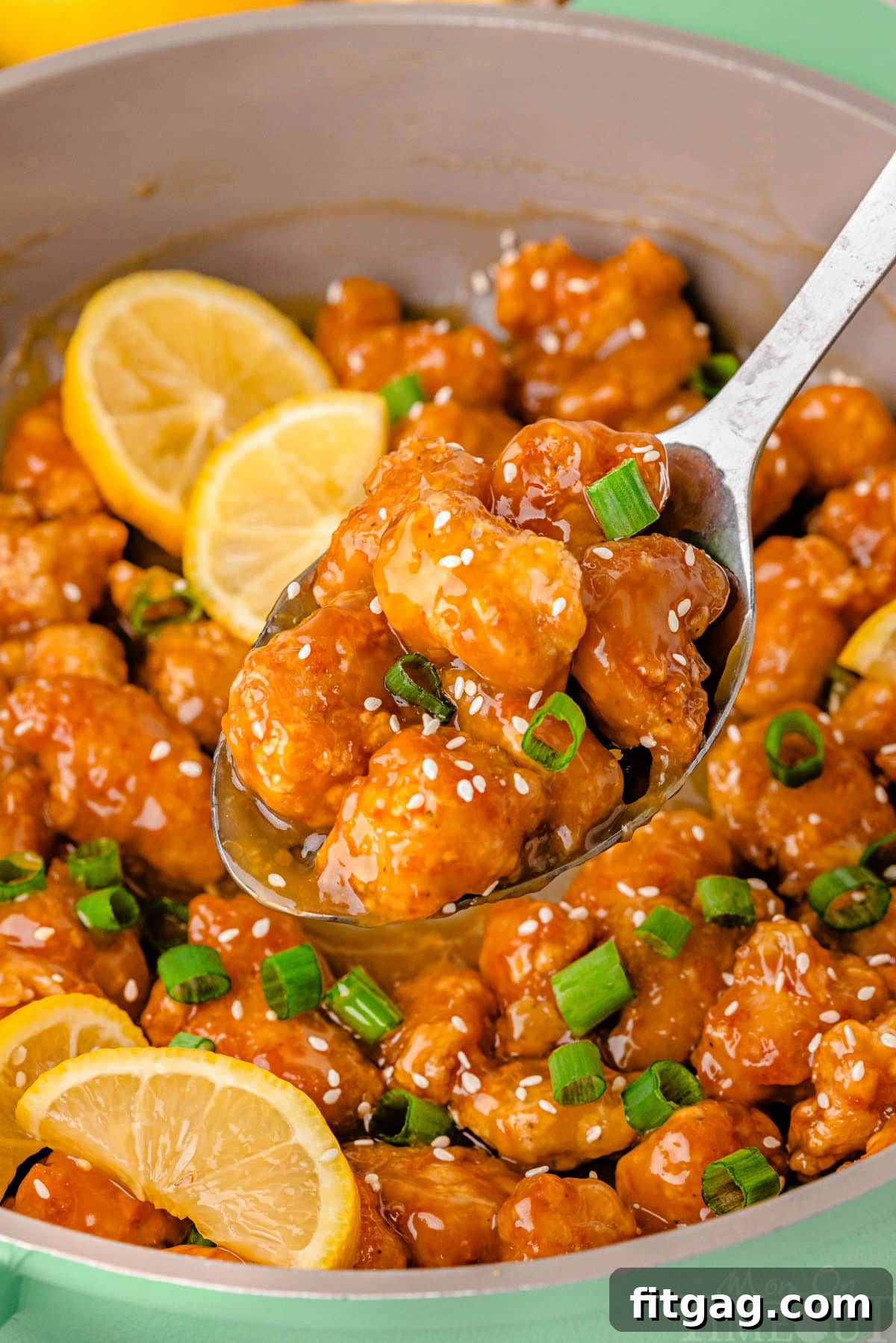 Golden Glazed Lemon Chicken 8 Lemon chicken chinese being served from skillet.