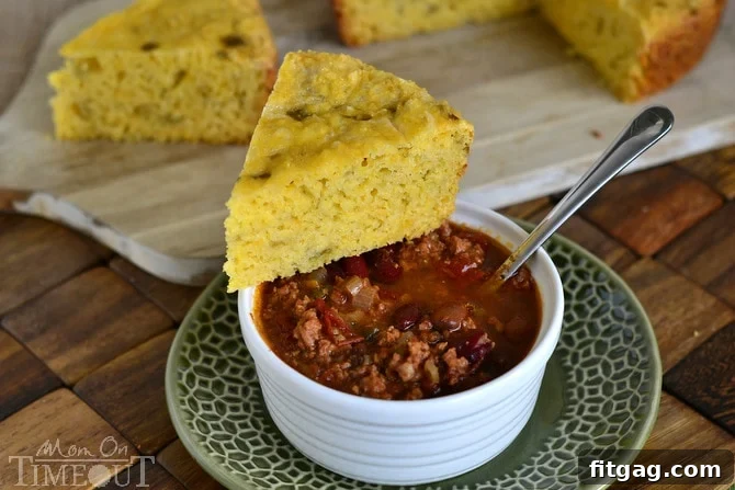 A slice of Slow Cooker Mexican Cornbread with a generous amount of green chiles and cheese