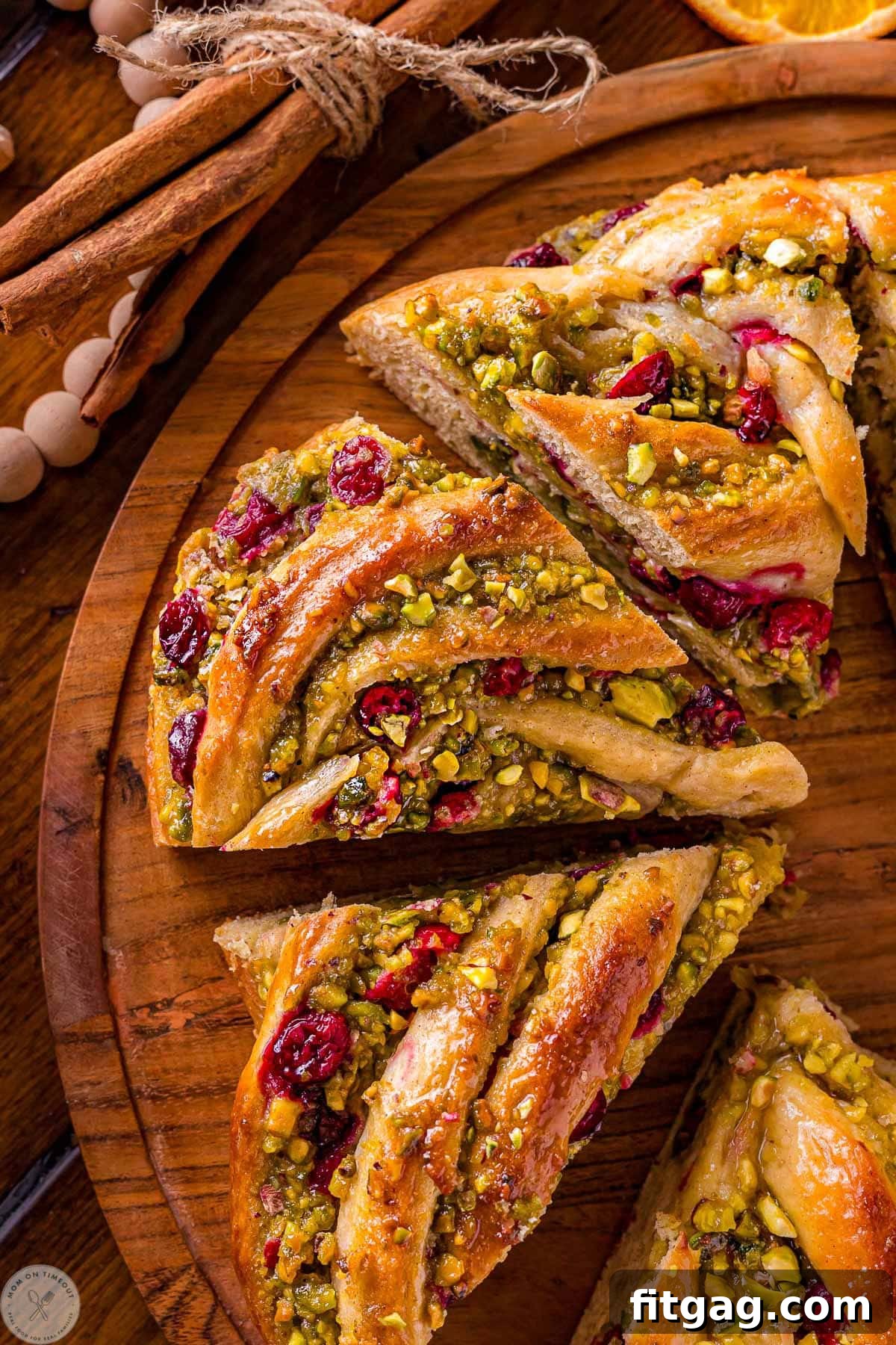Four pieces of babka bread wreath cut up on a round board.