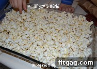 Popcorn being kept warm in a baking dish in the oven.