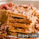 Toasted Pecan Brittle 11 Tall stack of pecan pie bark recipe with graham crackers. More pieces scattered around the stack.
