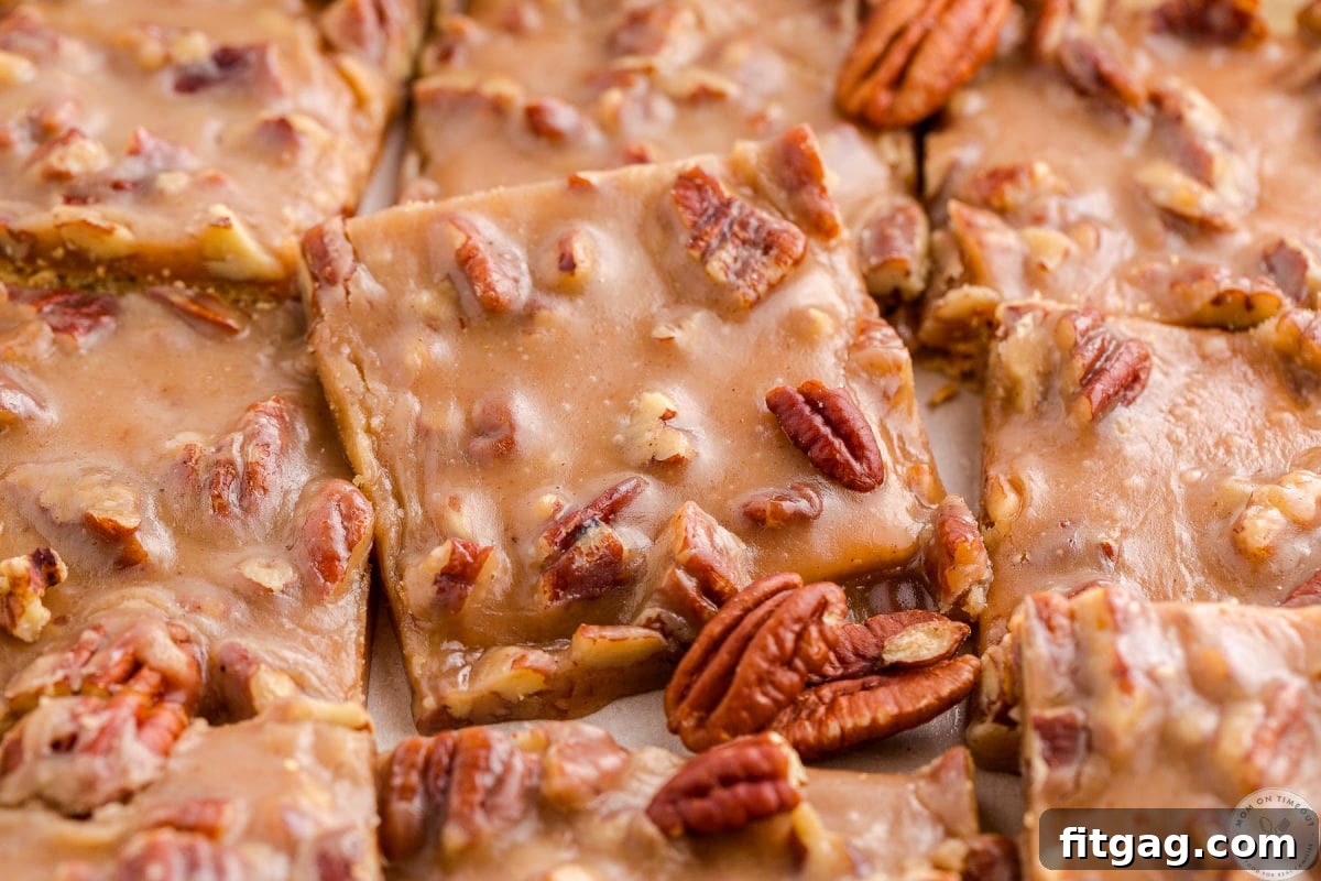Toasted Pecan Brittle 3 Wide shot of perfectly cut squares of pecan pie bark cooling in a baking sheet, ready to be enjoyed.