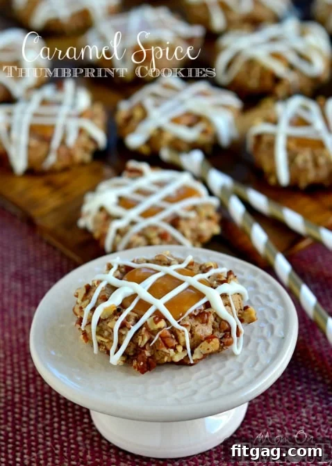 Close-up of a Caramel Spice Thumbprint Cookie revealing its soft, caramel-filled center and pecan crust.