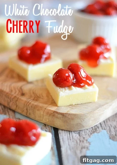 This White Chocolate Cherry Fudge requires only the microwave, and uses a special ingredient to make it extra light and fluffy! #recipe #fudge #white chocolate Close-up of perfectly sliced White Chocolate Cherry Fudge squares, showcasing the vibrant red cherries against the creamy white chocolate base. This easy microwave fudge recipe is perfect for any occasion.