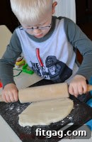 Close-up of a child's hand pressing into soft salt dough for a handprint ornament