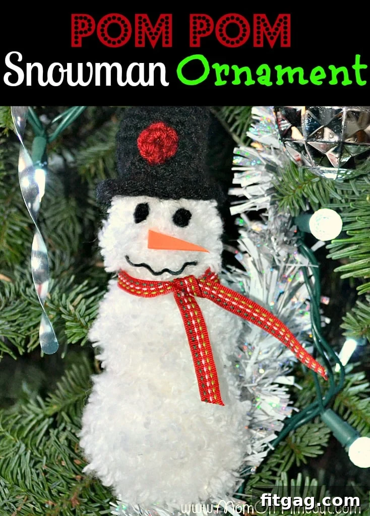 Charming handmade pom pom snowman ornament hanging on a Christmas tree