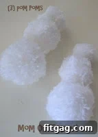Close-up of white yarn pom poms in various sizes