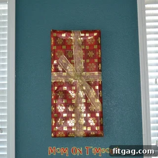 Small wrapped frame on a shelf with ornaments
