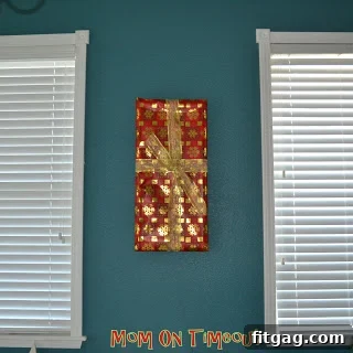 Decorated frame with red ribbon and holly