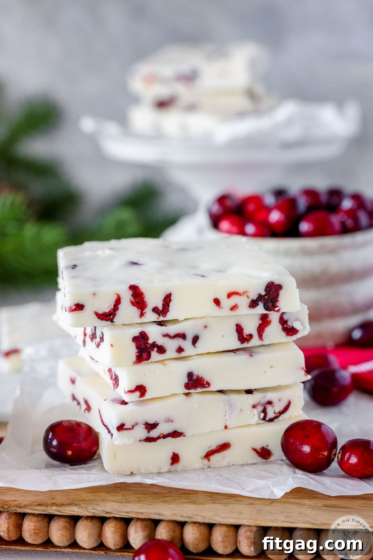 Five pieces of cranberry fudge stacked high, cut into large rectangles.