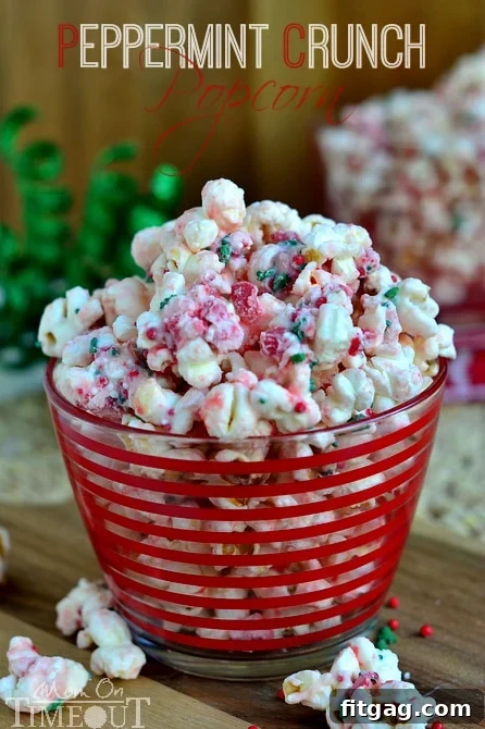 A small, red-striped bowl filled with Peppermint Crunch Popcorn, ready for a single serving, highlighting its appealing texture and color.