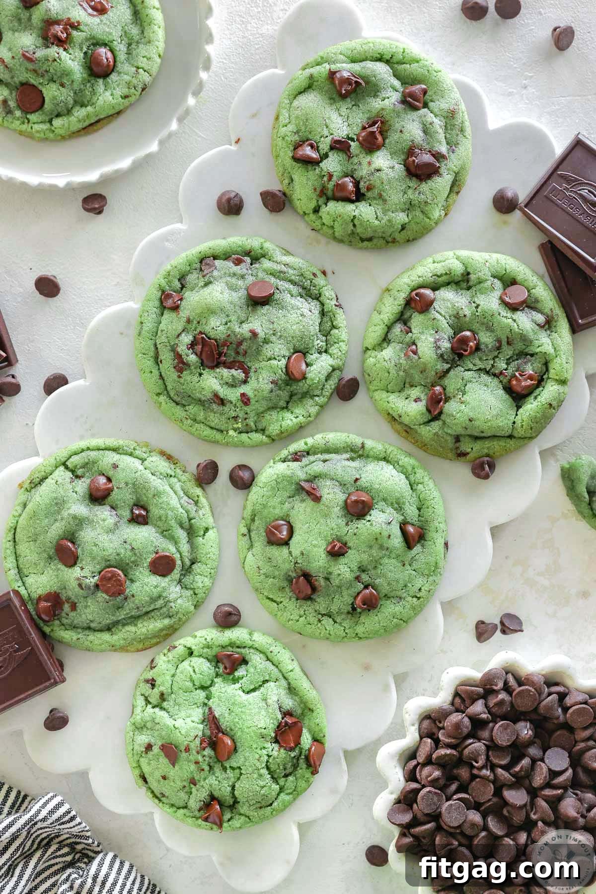 Close up look at chocolate chip and mint cookies on white marble board. 