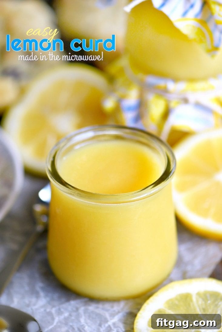 Silky smooth lemon curd in a clear glass jar, beautifully arranged with fresh lemon slices, highlighting its vibrant yellow hue and refreshing appeal.