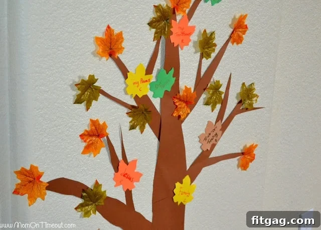 Family adding leaves to their Thanksgiving Gratitude Tree