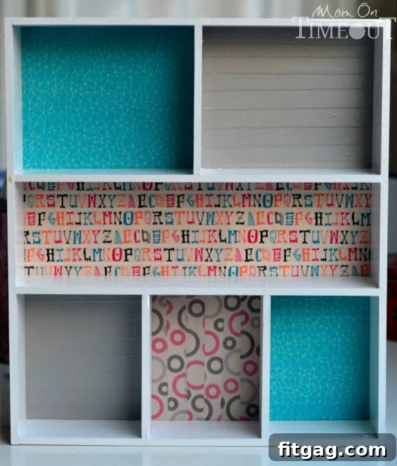White wooden dividers carefully placed on top of a colorful washi tape adorned plywood base, ensuring perfect alignment for the final drawer organizer assembly.