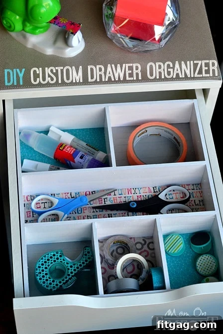 A completed custom DIY drawer organizer, vibrantly decorated with washi tape, neatly filled with office supplies and placed perfectly within a desk drawer, showcasing effective organization.