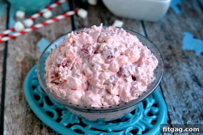 Airy Cherry Delight 3 A bowl of Cherry Fluff dessert salad, perfectly chilled and ready to serve, sitting on a blue trivet.