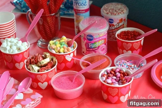 Valentine's Day cookie decorating supplies laid out for a fun kids' party.