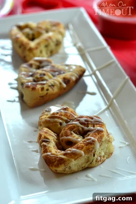 Heart-shaped cinnamon rolls, a festive and sweet treat for Valentine's Day parties.