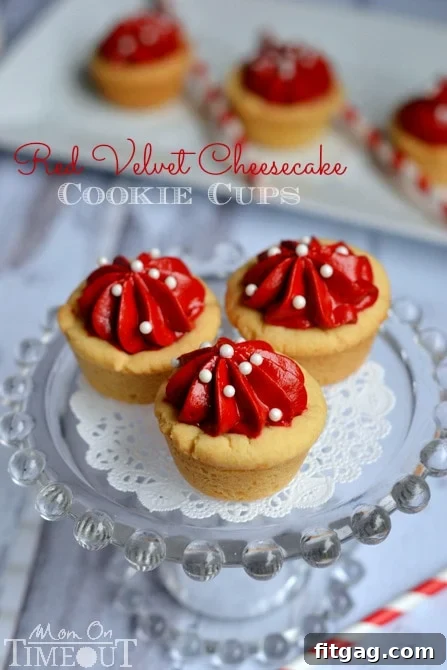 Close-up of a festive Red Velvet Cheesecake Cookie Cup, showcasing the vibrant red filling and cookie base. | MomOnTimeout.com