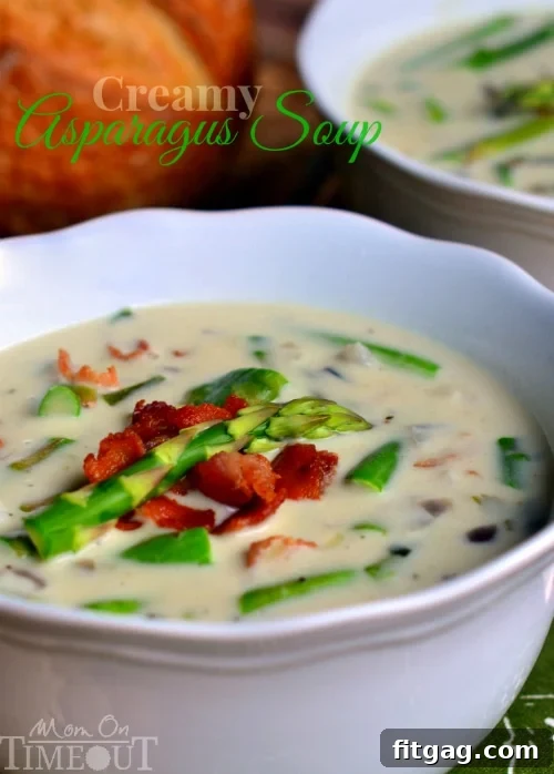 A steaming bowl of Mom's Creamy Asparagus Soup, garnished with fresh herbs, a perfect comfort meal.