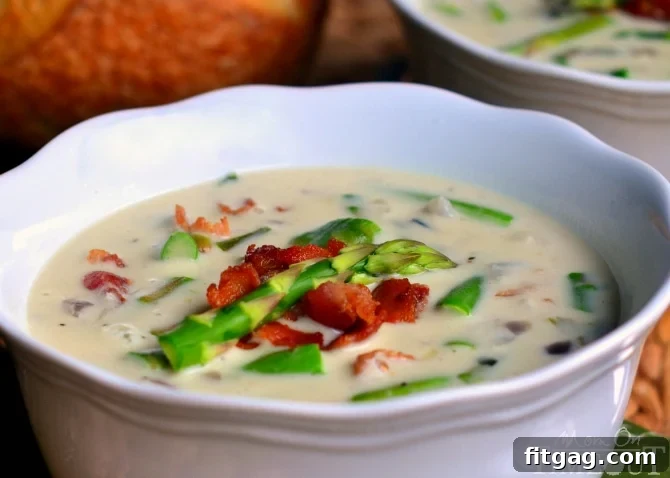 A close-up shot of creamy asparagus soup served in a rustic bowl, ready to be enjoyed.