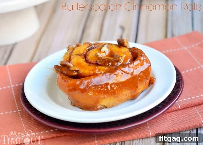 Perfectly Baked Butterscotch Pecan Cinnamon Rolls Ready to Serve A square baking dish showcasing a fresh batch of Butterscotch Pecan Cinnamon Rolls, still warm and covered in the sticky glaze.