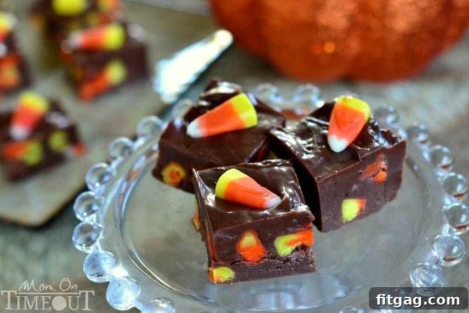 Close-up shot of homemade candy corn fudge showing the creamy texture and embedded candy corn pieces, a perfect Halloween dessert.