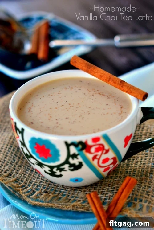 A steaming mug of homemade Vanilla Chai Tea Latte with a sprinkle of cinnamon, cozy comfort in a cup.