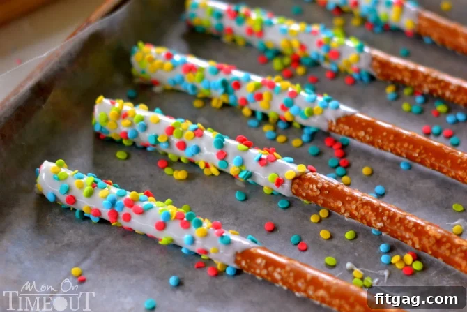 Easy Rainbow Pretzel Wands take just minutes to make and are perfectly scrumptious! | MomOnTimeout.com