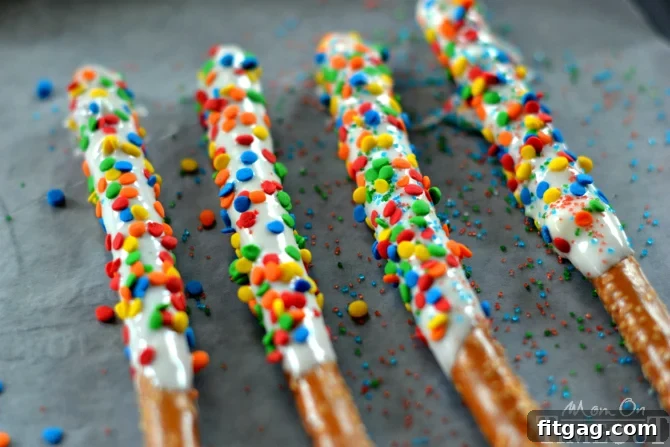 A close-up shot of more Easy Rainbow Pretzel Wands, perfect for a cheerful and quick party treat.