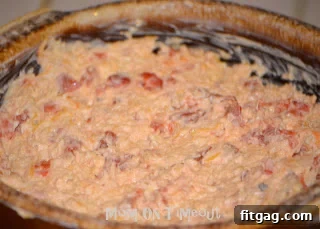 The dip ingredients thoroughly combined in a baking dish, ready for the oven.