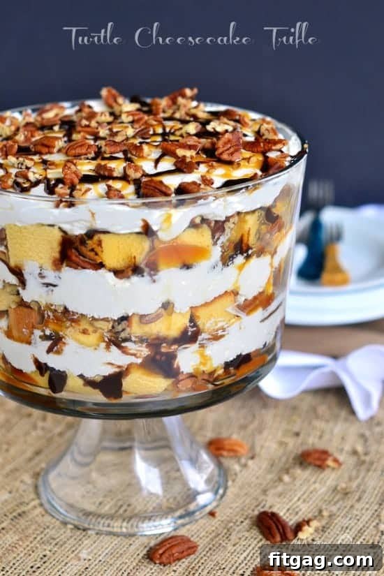 Turtle Cheesecake Trifle - Layers of caramel, chocolate, pecans, no bake cheesecake, and pound cake! A stunning Turtle Cheesecake Trifle featuring distinct layers of golden pound cake, creamy cheesecake, drizzled caramel, rich chocolate fudge, and sprinkled pecans.
