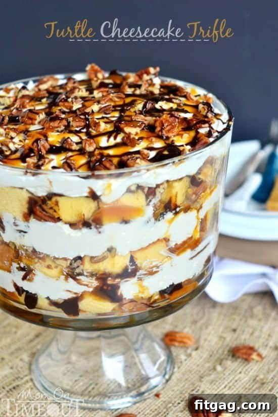 Turtle Cheesecake Trifle - Layers of caramel, chocolate, pecans, no bake cheesecake, and pound cake! Close-up of the Turtle Cheesecake Trifle showing a rich, layered slice with visible caramel, chocolate, pecans, and the creamy cheesecake resting on pound cake.
