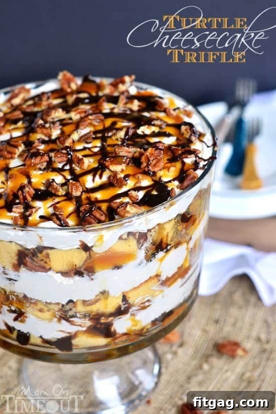 Turtle Cheesecake Trifle - Layers of caramel, chocolate, pecans, no bake cheesecake, and pound cake! A slice of Turtle Cheesecake Trifle, showcasing the intricate layers of pound cake, cheesecake, and rich caramel and chocolate sauces with pecans, ready to be enjoyed.
