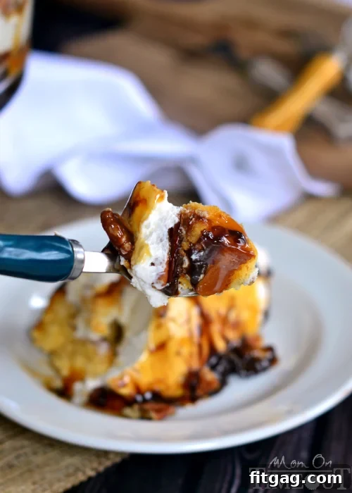 Turtle Cheesecake Trifle - Layers of caramel, chocolate, pecans, no bake cheesecake, and pound cake! A generous serving of Turtle Cheesecake Trifle presented on a white plate, highlighting the delightful combination of textures and flavors.