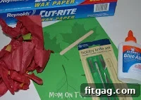 Autumn Leaf Suncatchers 3 Craft supplies laid out for Stained Glass Fall Leaves project, including glue, tissue paper, and waxed paper.