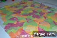 Autumn Leaf Suncatchers 8 Folding the waxed paper over the tissue paper mosaic and gently smoothing it out to ensure adhesion.