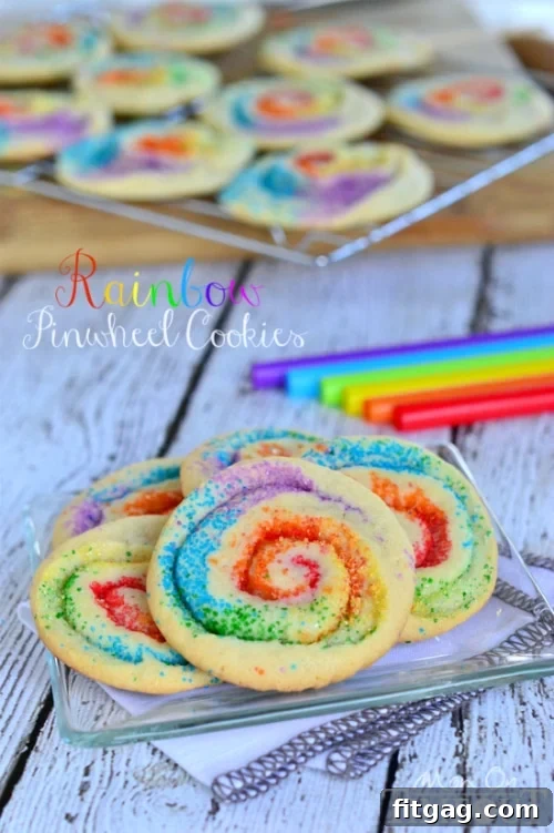 Rainbow sugar cookie dough before rolling, showcasing distinct color stripes for pinwheel effect.