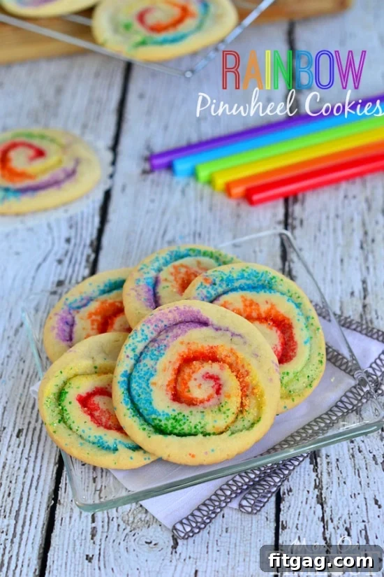 A serving plate filled with freshly baked Rainbow Pinwheel Cookies, ready to be enjoyed.