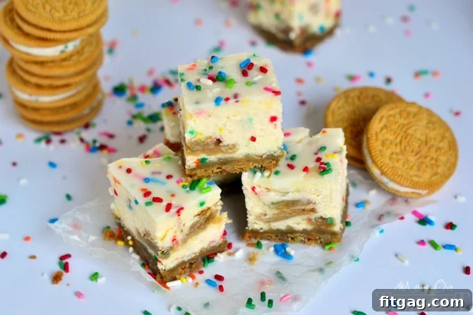 Funfetti Oreo Cheesecake Bars on a white plate, ready to be enjoyed. Close-up of a Funfetti Oreo Cheesecake Bar, highlighting crushed Oreo crust and colorful filling.