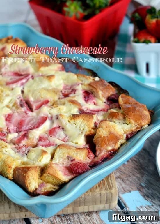Overnight Strawberry Cheesecake French Toast Casserole from MomOnTimeout.com Close-up of the Overnight Strawberry Cheesecake French Toast Casserole showing cubed bread, strawberries, and creamy filling before baking.