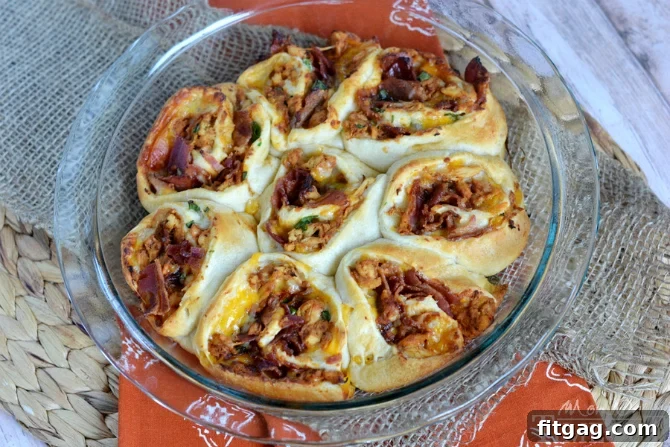 Freshly sliced green onions sprinkled over Cheesy BBQ Chicken Bacon Pinwheels