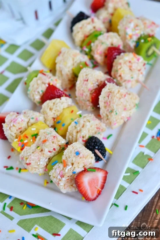 Close-up of neatly chopped fresh fruits and shaped Rice Krispies Treats ready for assembly onto skewers