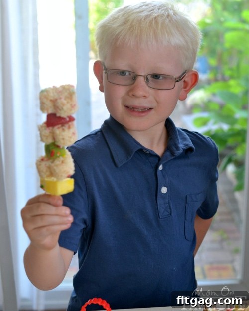Child holding a Funfetti Rice Krispies Treats Fruit Kabob