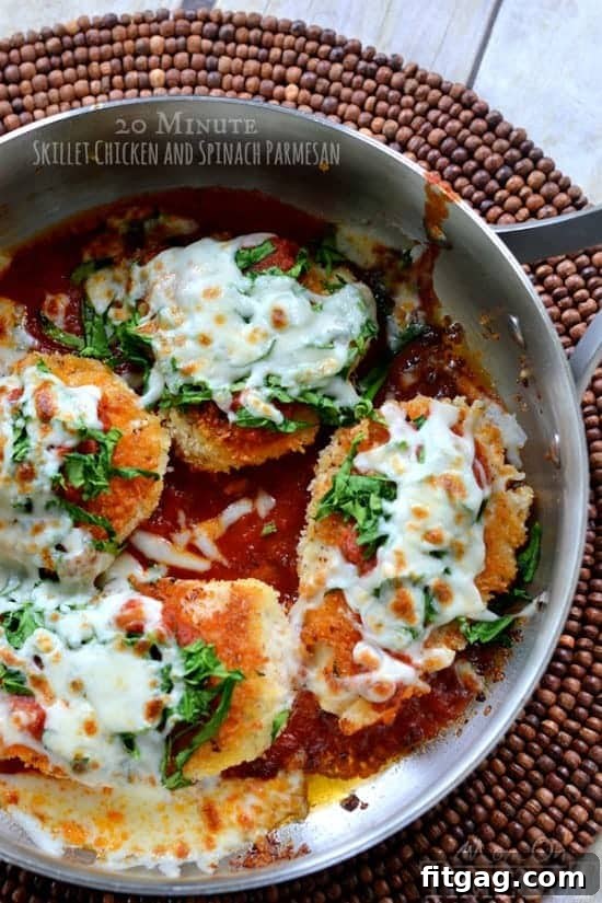 A beautifully cooked 20-Minute Skillet Chicken and Spinach Parmesan, garnished with fresh herbs and served in a skillet. This quick and easy dinner is perfect for busy weeknights.